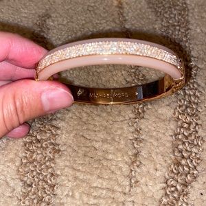 Michael Kors rose gold bracelet with with a strip of diamonds on top of bracelet